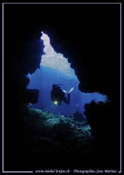 My wife at the entry of a cave in the Red Sea... :O)... by Michel Lonfat 